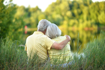 Wall Mural - Loving mature couple in the park in summer