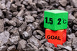 © Rochu_2008 - Symbol of reducing global warming among coal piles. A rotating wooden cube with the symbol '2 C' changing into '1.5 C' concept, reducing global warming or vice versa. reduction of fossil fuels