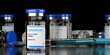 © Shawn Hempel - Group of testosterone steroid vials with syringe in the center on black background, anabolic steroid for muscle growth , selective focus
