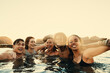 © Jacob Lund - Group of friends enjoying a fun travel experience swimming in the ocean at sunset