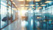© Mr. Music - A blurry view of a modern office space with glass doors and windows, featuring natural light and bright colors.