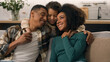 © Yuliia - Happy African American ethnic family mother woman father man little boy son smiling loving parents embracing kid child laughing talk relaxing together weekend rest sofa couch indoors house living room