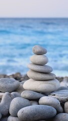 Wall Mural - Zen meditation background - balanced stones stack cairn close up on sea beach