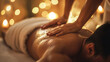 © Frank Gärtner - Close up of a massage therapist massaging a male client's back during a serene spa treatment session