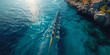 © mattegg - 'Top Aerial View: Sport Canoe Rowing Team Synchronized Competition in Blue Sea'