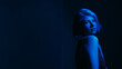© golubovy - Depressed woman. Mental problems. Worried female social anxiety concerned looking back monochrome neon blue lights dark background empty space.