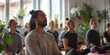 © Oleksandr - An Arab man with a ponytail meditates during yoga classes. He is surrounded by other yoga class participants of varying ages, genders and races. The yoga practitioner looks calm and relaxed.