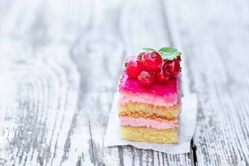 Wall Mural - Piece of the layered berry cake with fresh red currant on white table