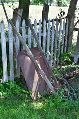 Wall Mural - Wheelbarrow by a Wooden Fence