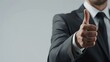 © Doni_Art - a businessman gives a thumbs up on a white background