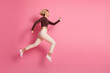© deagreez - Photo of positive cheerful girl wear trendy brown clothes run fast empty space isolated on pink color background