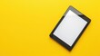 © TheWaterMeloonProjec - Contemporary e reader with screen on yellow background top down view Text space