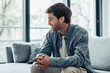 © Daniel - Positive thoughtful relaxed middle aged man sitting on comfortable couch, looking at window away, thinking, daydreaming, enjoying home leisure, silence, relaxation, comfort, smiling.
