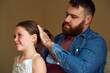 © Chithambo/peopleimages.com - Father, daughter and hairstyle in bonding with care, affection and love in home for happiness as family. Male parent, girl and smile in routine for together, memory or support in child development