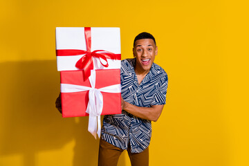 Canvas Print - Photo of funky cheerful guy dressed print shirt holding birthday gift isolated yellow color background