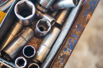 Wall Mural - Mechanic tools engineering equipment car auto repair shop with copy space. Blurred background mechanical service. Heavy screw grungy rusted wrenches dirty screwdriver object. Industrial hardware set