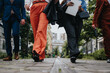 © qunica.com - A group of professionals in stylish business attire walking in an urban setting, conveying teamwork and modern business concepts.