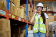 © offsuperphoto - factory worker talking on smartphone to customer in warehouse factory
