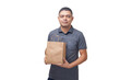 © Gideoni Junior - Delivery man holding cardboard box and paper packaging. Delivery concept. Delivery boy concept.