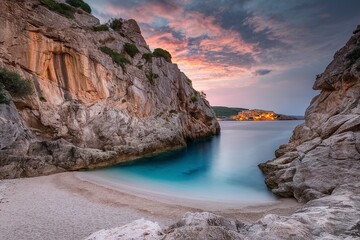 Wall Mural - The stone coast of the Mediterranean Sea at sunset