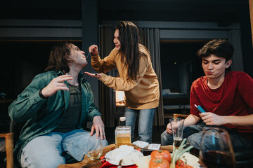 Poster - A group of friends share a fun moment while playing a game and enjoying alcoholic beverages and snacks indoors.