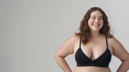 Joyful smiling woman beams with self-assurance and happiness, embodying the essence of body positivity and self-love against a plain backdrop. Banner with copy space and mockup