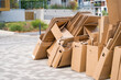 © Valeriia - Pile of cardboard boxes ready for recycling outside a building