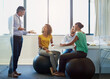 © ArcursPI/peopleimages.com - Creative, team and business people with leader for training, coaching or brainstorming in startup office. Group, planning and discussion for strategy, project and editor on fitness ball for exercise