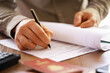 © alexkich - Businessman Signing Important Document - Close-up of Hand with Pen Signing Paperwork