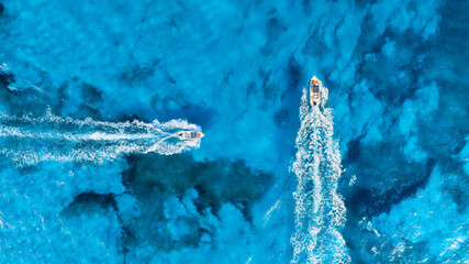 Wall Mural - vacation and leisure. aerial view on fast boats on blue sea at sunny day. fast ship on the sea surfa