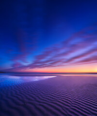 Wall Mural - seascape during sunrise. long exposure. lines of sand on the seashore. bright sky during sunset. a s