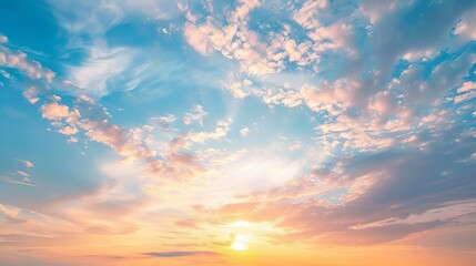 A real majestic sunrise or sunset sky background with gently colorful clouds, devoid of birds. This panoramic image is in a big size, ideal for various uses.