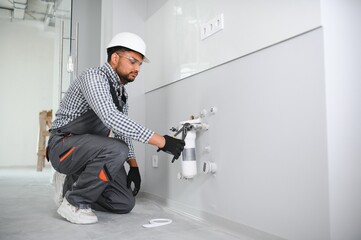 Wall Mural - plumber installing water equipment - meter, filter and pressure reducer