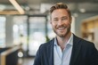 © Vlad - Handsome Male Professional Smiling in Blazer, Standing in Office with Copy Space