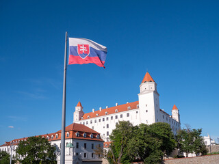 Bratislava, Slovakia. Bratislava Castle is built on a hill above the old town. Popular tourist destination. The flag of the Slovak Republic flies in front of the castle.