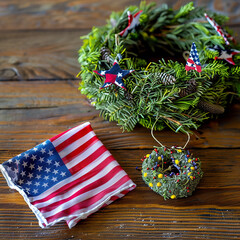 Handkerchief with an American flag motif near a Memorial Day floral wreath.