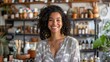 © Lakkhana - Attractive multiethnic entrepreneur in her boutique, smiling at the camera with products in the background