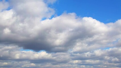 Wall Mural - Huge, low clouds slowly move across the sky. Cumulus white clouds with dark bottoms.
