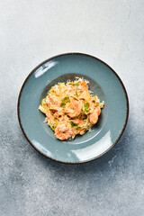 Wall Mural - Italian pasta with shrimp and parmesan cheese. In a plate. Restaurant dish. Close up.