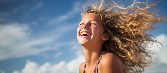 Poster - A happy and playful teenage girl is captured in a portrait outdoors enjoying her summer vacation with a joyful and carefree expression on her face The image depicts the essence of a happy and carefre