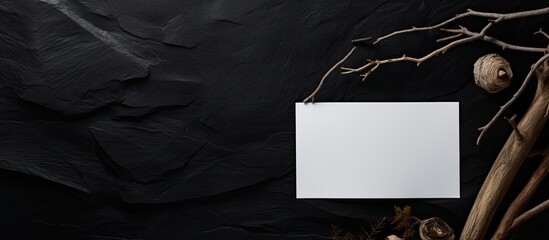Leinwandbilder - A copy space image featuring a pencil dry branch and blank paper placed on a black plaster background alluding to a responsive design mockup