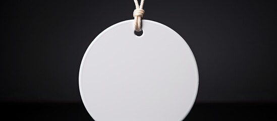 Aufkleber - Close up of a white round label mockup with a white cord The blank paper price tag is isolated on a black background with copy space for Sale and Black Friday concept