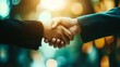 © Natalia - Close-up of two business professionals shaking hands with a blurred background and warm lighting, symbolizing partnership and agreement.