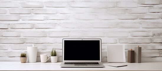 Aufkleber - A modern designer desk with a blank laptop smartphone supplies and other items There is a white brick wall background creating a web design concept The image showcases a mock up. Creative banner