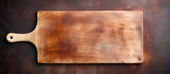 Wall Mural - A top down view of a rectangular vintage style cutting board with a handle and a wooden spoon The image features empty space for copy or other elements