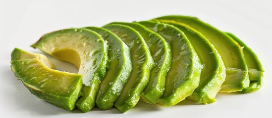 Wall Mural - Close-up of sliced avocado on a white background.