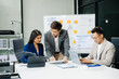 © laddawan - Office colleagues have a casual discussion. During a meeting in a conference room, a group of Asian business teem sit in the conference room