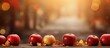© HN Works - Autumn themed apples are placed on a wooden table against a blurred background with a bokeh effect creating a visually appealing copy space image