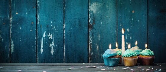 Aufkleber - A festive background with copy space image on vintage blue boards adorned with pie decorations and a candle number 4 for a birthday celebration
