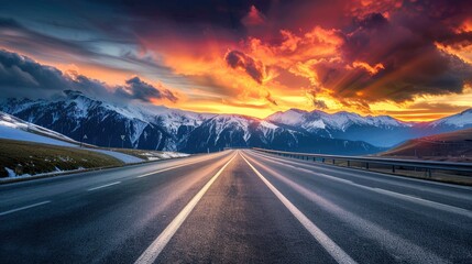 Empty highway in the beautiful italian Alps, sky illuminated by the sun's rays at sunset, incredible nature, bright saturated colors